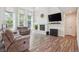 Bright living room featuring a fireplace, tall ceilings, and wood flooring at 1762 Red Fox Pl, Highlands Ranch, CO 80126