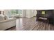 Bright living room with wooden flooring, large windows, and neutral decor at 1762 Red Fox Pl, Highlands Ranch, CO 80126