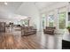 Bright living room with soaring ceilings and abundant natural light flows to the open kitchen at 1762 Red Fox Pl, Highlands Ranch, CO 80126