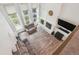 Open living room with tall windows, fireplace, and comfortable seating area at 1762 Red Fox Pl, Highlands Ranch, CO 80126