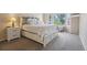 Spacious main bedroom with large bed, bedside tables and a sun-filled window at 1762 Red Fox Pl, Highlands Ranch, CO 80126