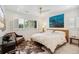 Bedroom with paneled walls, shutters, ceiling fan, and cowhide rug at 2981 Teller St, Wheat Ridge, CO 80033