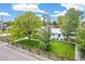 Well-manicured front yard with mature trees and a charming fence enhancing curb appeal at 2981 Teller St, Wheat Ridge, CO 80033