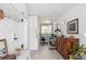 Hallway boasts white brick walls, modern tile floors, and opens to an office with patterned wallpaper at 2981 Teller St, Wheat Ridge, CO 80033