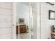 Hallway between rooms features a wood cabinet and a view into another room at 2981 Teller St, Wheat Ridge, CO 80033