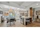 Open kitchen boasts tile floors, an island with bar stool seating and modern lighting fixtures at 2981 Teller St, Wheat Ridge, CO 80033