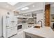 Bright kitchen with updated appliances, including a white refrigerator and stainless steel oven at 2981 Teller St, Wheat Ridge, CO 80033