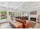 Bright living room featuring a fireplace, hardwood floors, and access to the outdoors at 2981 Teller St, Wheat Ridge, CO 80033