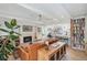 Cozy living room with fireplace, comfortable seating, and view into open kitchen area at 2981 Teller St, Wheat Ridge, CO 80033