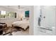 Main bedroom featuring paneled walls and an ensuite bathroom with glass shower at 2981 Teller St, Wheat Ridge, CO 80033