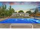 Twilight view of the backyard pool, outdoor dining, and entertainment area at 2981 Teller St, Wheat Ridge, CO 80033