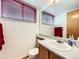 Clean, functional bathroom with sink, toilet, vanity, neutral color palette, and bright natural light at 6154 Quitman St, Arvada, CO 80003
