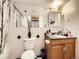 Cozy bathroom featuring black and white accents, a pedestal sink, and decorative vanity at 6154 Quitman St, Arvada, CO 80003