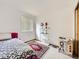 Cozy bedroom featuring a patterned bedspread, an accent rug, and a window with blinds for a relaxing ambiance at 6154 Quitman St, Arvada, CO 80003
