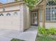 Close up of home showing front door, brick accents, and manicured landscaping at 6154 Quitman St, Arvada, CO 80003