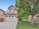 Charming two-story home with a well-maintained front yard and a two-car garage at 6154 Quitman St, Arvada, CO 80003