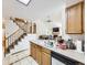 Bright kitchen featuring stairs to the second floor, a large sink and a view into the living room at 6154 Quitman St, Arvada, CO 80003