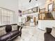 Bright and spacious living room with open floor plan and dining area, showcasing high ceilings and second-floor balcony at 6154 Quitman St, Arvada, CO 80003