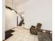 Inviting living room featuring tile flooring, high ceilings, and a view of the staircase, creating an open atmosphere at 6154 Quitman St, Arvada, CO 80003