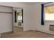 Cozy bedroom with a mirrored closet and large windows with curtains at 9155 E Center Ave # 1A, Denver, CO 80247
