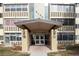Building entrance featuring the address, double doors, and a covered entryway at 9155 E Center Ave # 1A, Denver, CO 80247