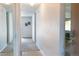 Hallway featuring mirrors on the wall, carpet and tile flooring, and an open doorway to another room at 9155 E Center Ave # 1A, Denver, CO 80247