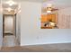 Hallway with a peek into the kitchen area featuring wooden cabinets and recessed lighting at 9155 E Center Ave # 1A, Denver, CO 80247