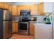 Kitchen with stainless steel appliances, white countertops, and light wood cabinets at 9155 E Center Ave # 1A, Denver, CO 80247