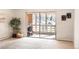 Bright living room featuring a large glass door and neutral carpet at 9155 E Center Ave # 1A, Denver, CO 80247