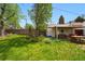 Serene backyard scene highlighting the well-manicured lawn and charming covered patio area at 5674 S Prescott St, Littleton, CO 80120
