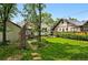Beautifully landscaped backyard featuring lush greenery, charming walkways, and a cozy patio at 5674 S Prescott St, Littleton, CO 80120