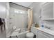 Bathroom with a tub-shower combo and white tile at 5674 S Prescott St, Littleton, CO 80120