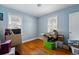 Bright bedroom featuring hardwood floors, two windows, and neutral walls at 5674 S Prescott St, Littleton, CO 80120