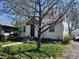 Quaint single-story home featuring a well-kept lawn, mature trees, and inviting front entrance at 5674 S Prescott St, Littleton, CO 80120