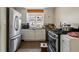 Functional kitchen with stainless steel appliances, ample counter space, and bright natural light at 5674 S Prescott St, Littleton, CO 80120
