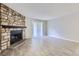 Bright living room with a stone fireplace and neutral flooring at 18193 E Kentucky Ave # 204, Aurora, CO 80017