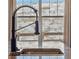 Close up of a modern kitchen featuring granite countertops, stainless steel sink, and a black faucet at 3375 Umber Cir, Castle Rock, CO 80109