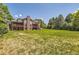 Expansive backyard with brick home and treed border at 4681 S Columbine Ct, Cherry Hills Village, CO 80113