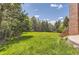 Expansive backyard with lush lawn and mature trees at 4681 S Columbine Ct, Cherry Hills Village, CO 80113