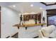 Bar area with seating, wood counter top, and bar cabinets. Includes modern sculptures at 4681 S Columbine Ct, Cherry Hills Village, CO 80113