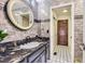 Modern bathroom featuring granite countertops, updated fixtures, and a decorative mirror at 4681 S Columbine Ct, Cherry Hills Village, CO 80113