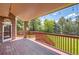 Spacious covered deck with wood railing and view of the backyard at 4681 S Columbine Ct, Cherry Hills Village, CO 80113