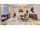Elegant dining room featuring marble floors, modern chandelier and an adjacent window at 4681 S Columbine Ct, Cherry Hills Village, CO 80113