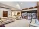 Open living area featuring a vaulted ceiling, wet bar, and walkout to a patio at 4681 S Columbine Ct, Cherry Hills Village, CO 80113