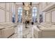 Luxurious living room with marble flooring, tall windows, chandelier, and fireplace at 4681 S Columbine Ct, Cherry Hills Village, CO 80113