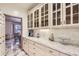 Butlers pantry with granite countertop and glass-front cabinets at 4681 S Columbine Ct, Cherry Hills Village, CO 80113