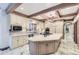 Island kitchen with granite countertops, double ovens, and custom cabinetry at 4681 S Columbine Ct, Cherry Hills Village, CO 80113