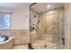 Large walk-in shower with tiled walls and built-in seat at 4681 S Columbine Ct, Cherry Hills Village, CO 80113