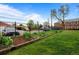 Well-maintained backyard with lush green grass, flower beds, and a sturdy fence providing privacy and security at 2867 Jasmine St, Denver, CO 80207