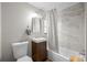 Modern bathroom with a sleek vanity, white marble tile, and a bathtub with a stylish shower curtain at 2867 Jasmine St, Denver, CO 80207